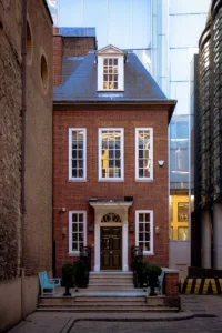 a red brick building with white windows and steps leading up to it